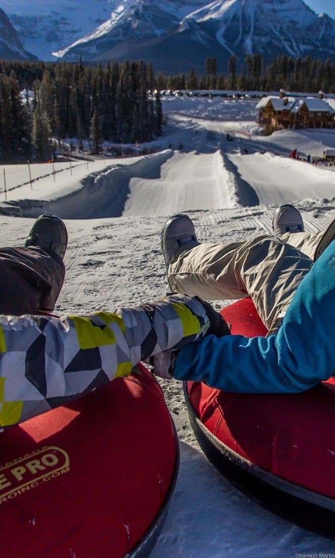 Tubing down a snowy slope in the Rockies